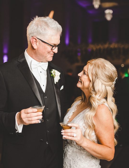 bride and groom holding cocktails